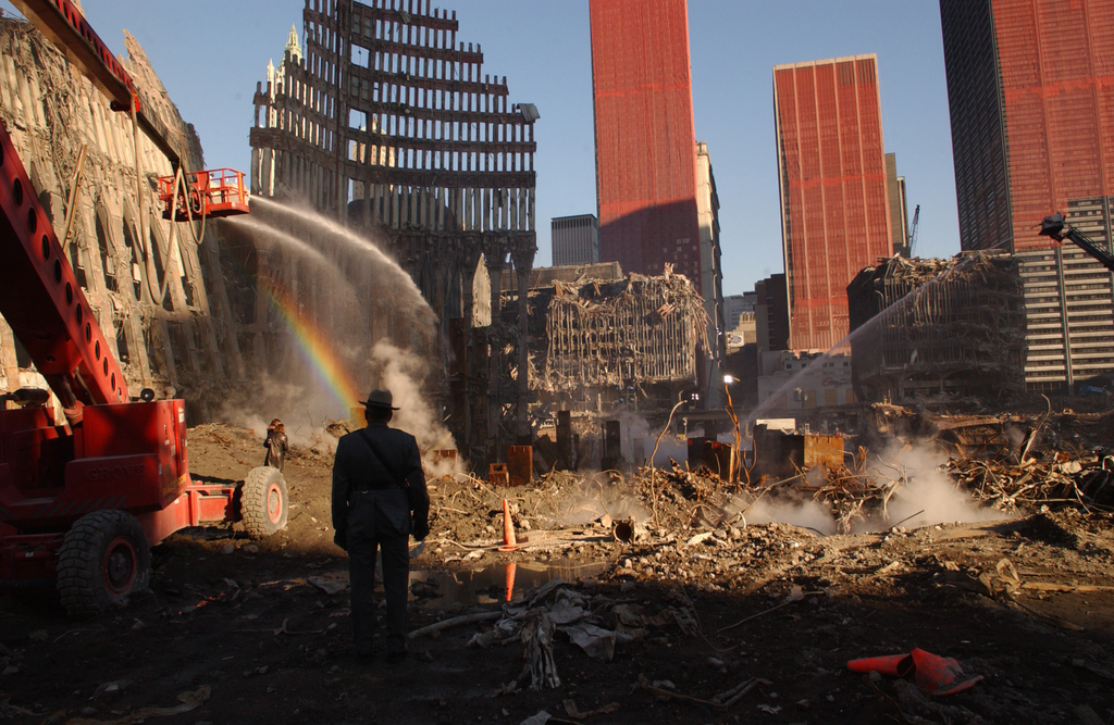 Looking east, through the core of WTC1, there is still fuming from the wet dirt. WTC-5 in back across plaza and WTC-4 on right