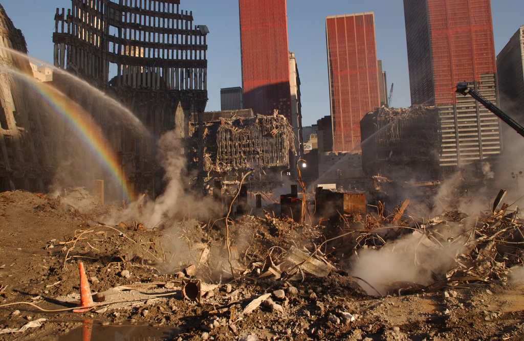 Looking east, through the core of WTC1, there is still fuming from the wet dirt. WTC-5 in back across plaza and WTC-4 on right