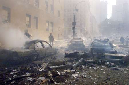 'fuming cars' on Vesey Street, facing east, near the Church Street intersection. The Postal Building is on the left and WTC5 is on the right.