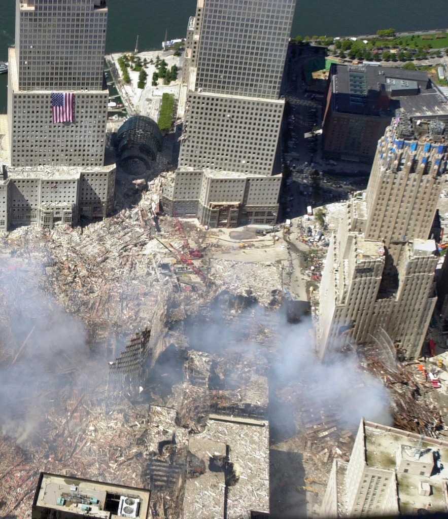 WTC-7 fuming; Looking West over the site of where WTC7 stood. The water shooting out of the Verizon building does not cause steam. The appearance of 